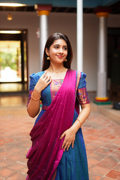 Close-up of the magenta silk georgette dupatta draped over the peacock blue pleated gown.