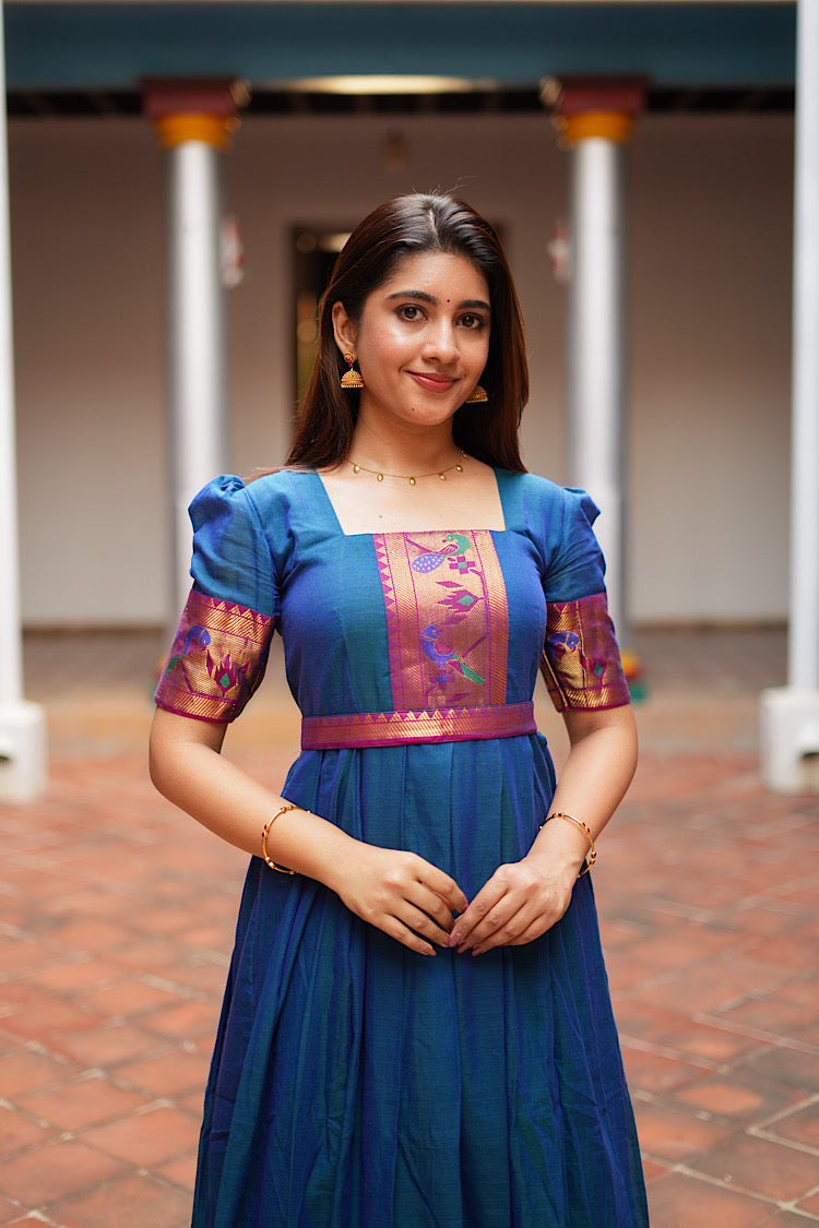 Close-up of the square neckline and Paithani border patch on the peacock blue dress.