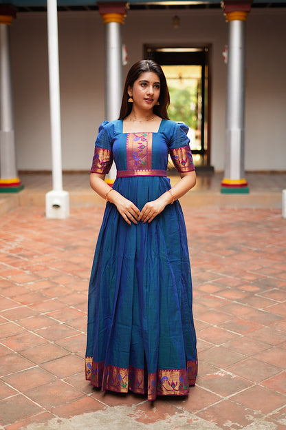 Front view of the peacock blue pleated maxi dress showing the square neck and Paithani border yoke.