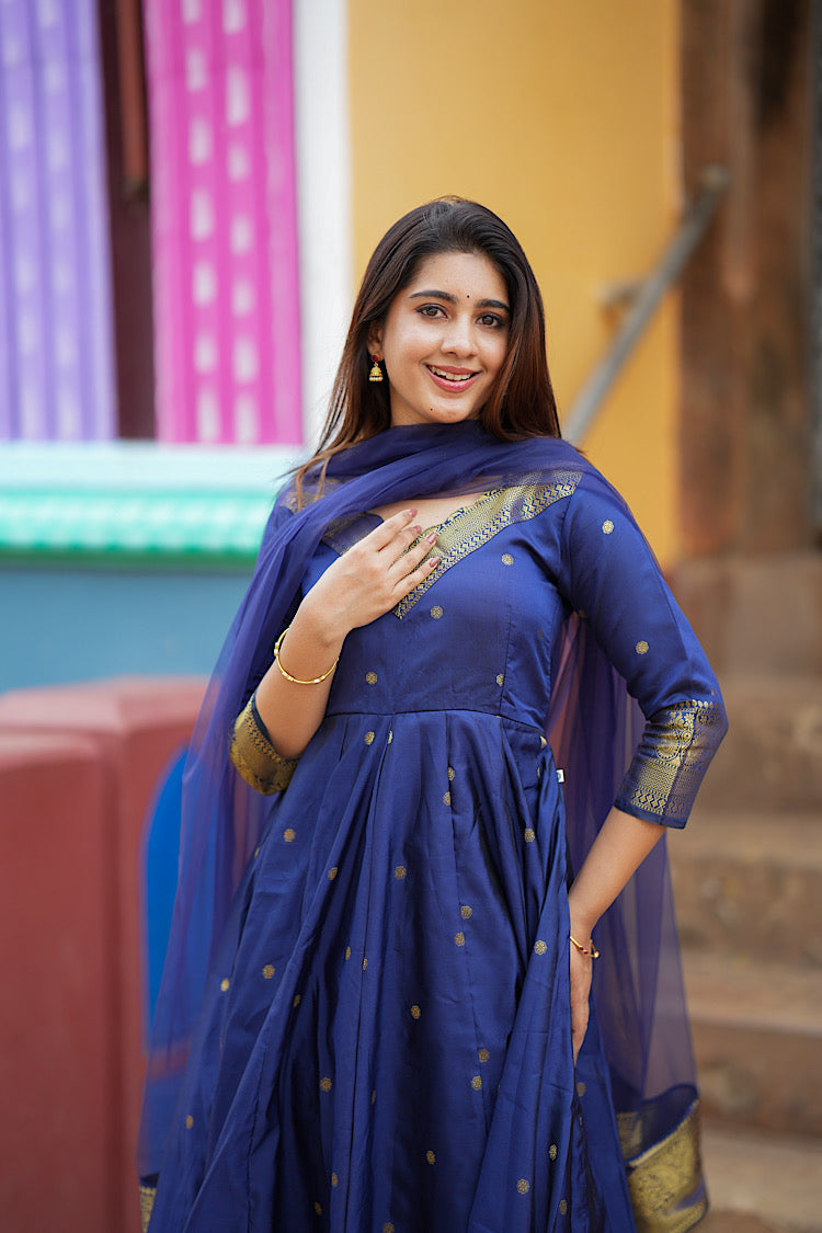 Close-up of the royal blue silk anarkali showing the gold zari work on the neckline and sleeves