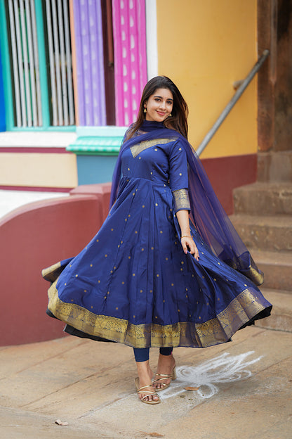 Twirling shot showing the wide flare of the royal blue panelled anarkali suit