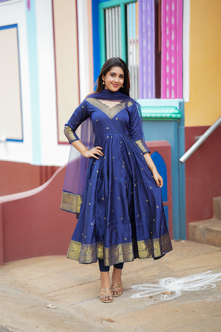 Full-length view of the flared royal blue silk anarkali dress with gold borders