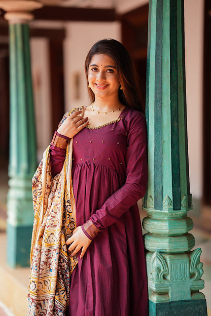 Side profile of the maroon kurti set with dupatta showing the flowy flare of the cotton fabric
