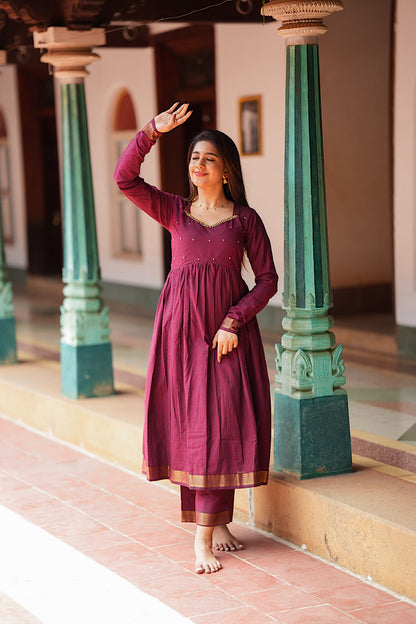 Full-length view of the maroon mangalgiri cotton anarkali suit showing the gathered flare and zari hemline
