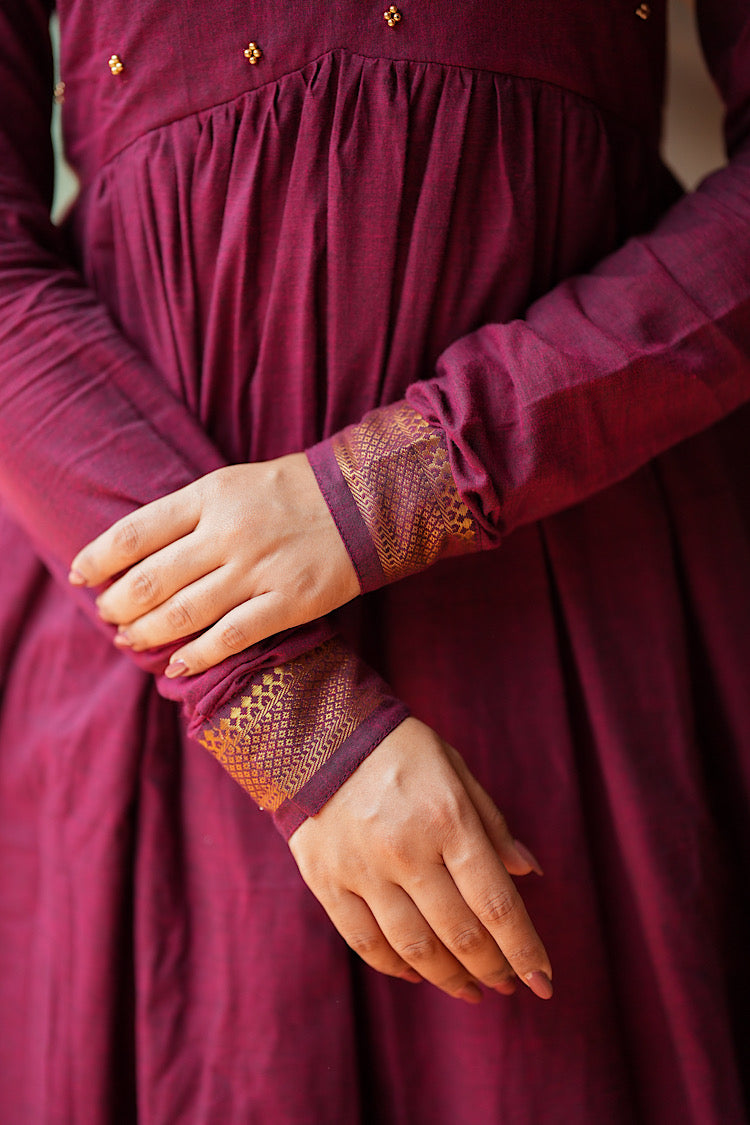 Detailed view of the full sleeves with woven gold zari cuffs on the maroon cotton kurti