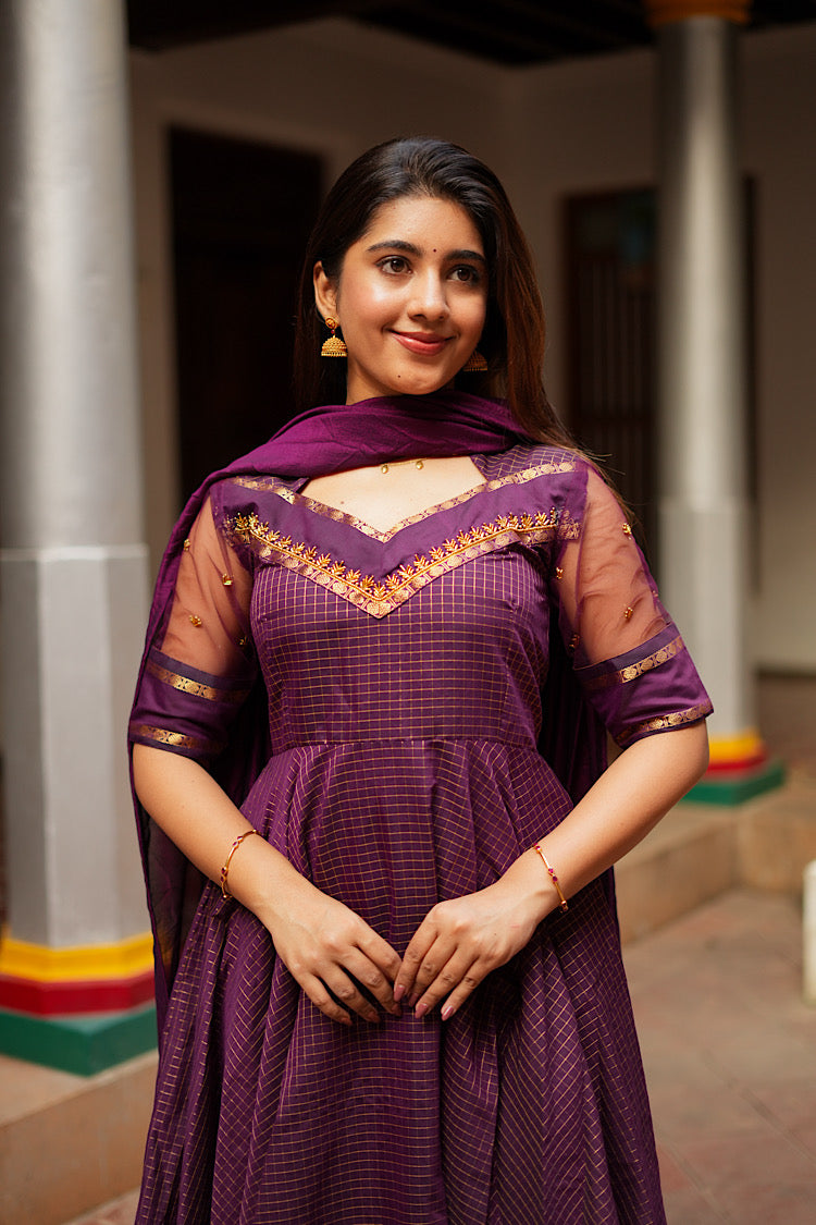 Close-up of the V-neckline with gold Aari embroidery on the Aarya purple anarkali suit.