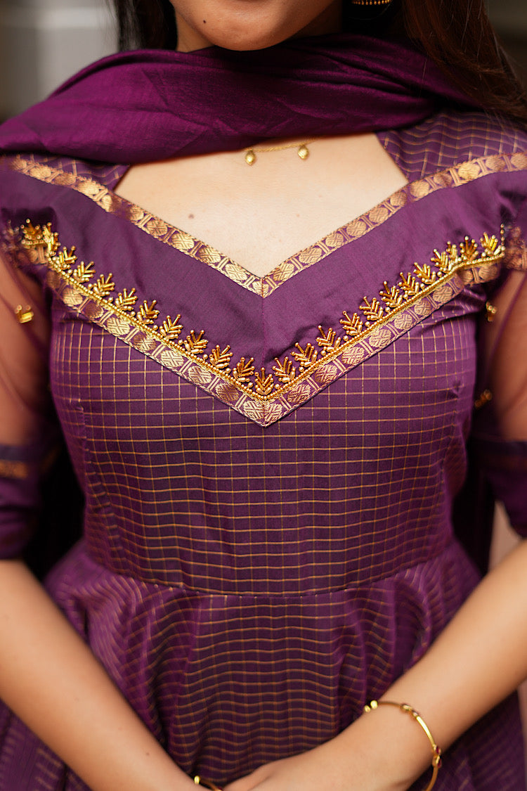 Detailed close-up of the V-shaped yoke with intricate gold Aari work embroidery.