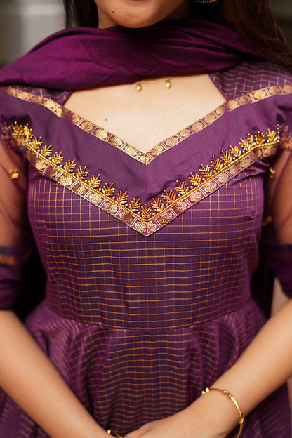 Detailed close-up of the V-shaped yoke with intricate gold Aari work embroidery.