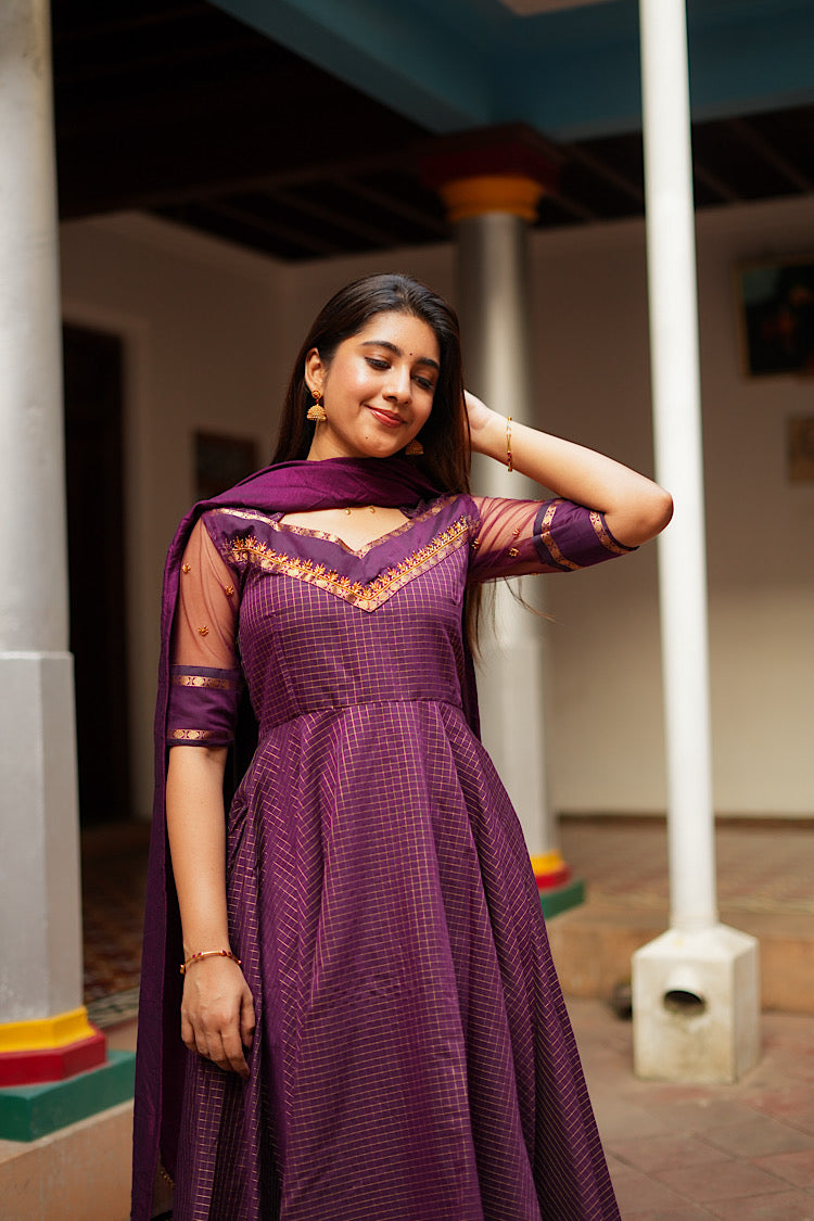 Aarya designer anarkali dress highlighting the sheer net sleeves with gold buttas.
