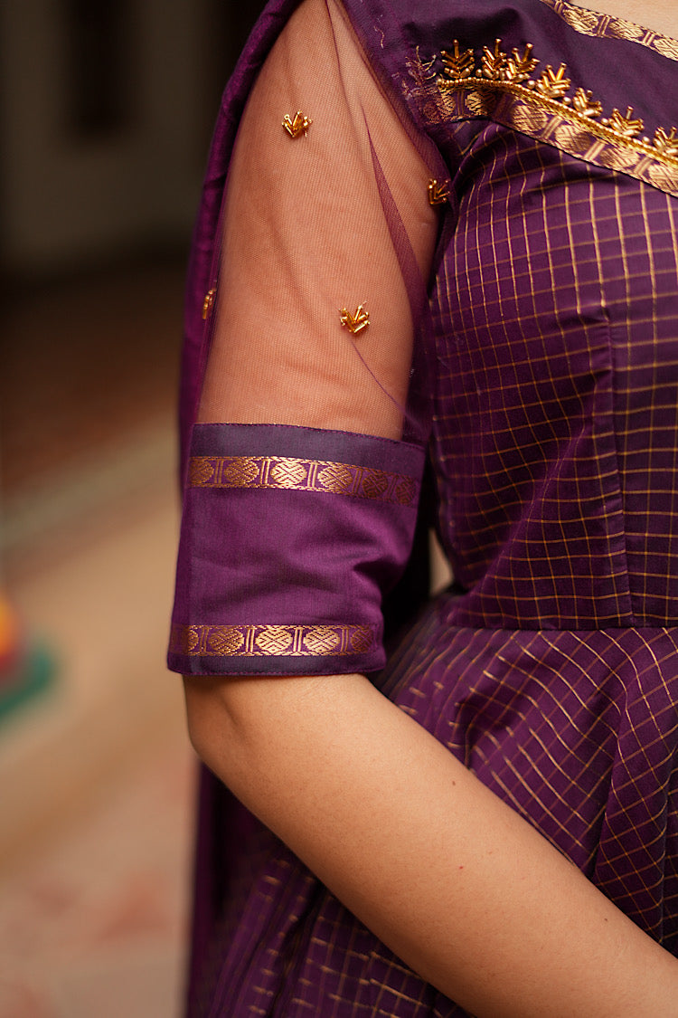 Close-up of the sheer net elbow sleeve with gold zari borders and delicate buttas.