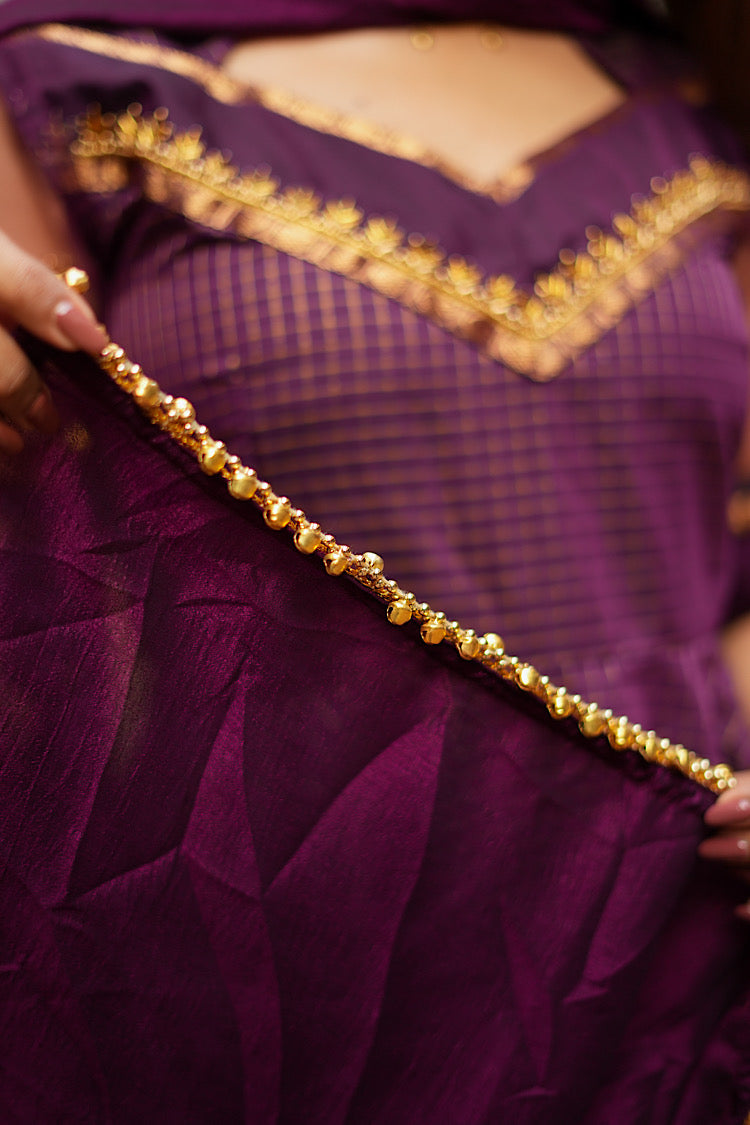 Close-up of the vine purple dupatta finished with a delicate gold bead lace trim.