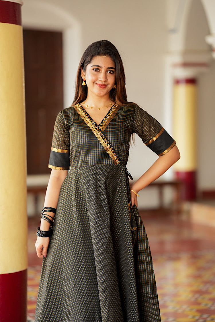 Close-up of the angrakha neckline with gold Aari embroidery on the black silk dress