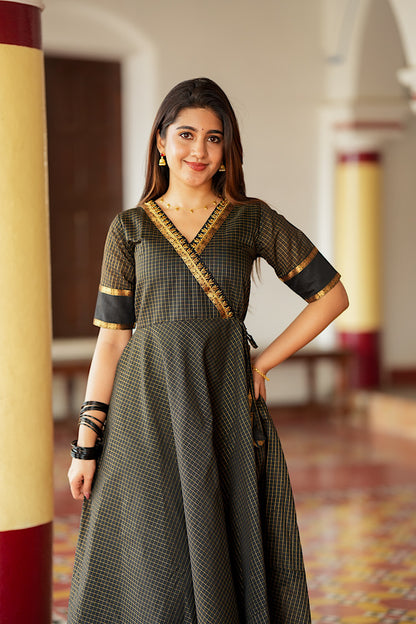 Close-up of the angrakha neckline with gold Aari embroidery on the black silk dress