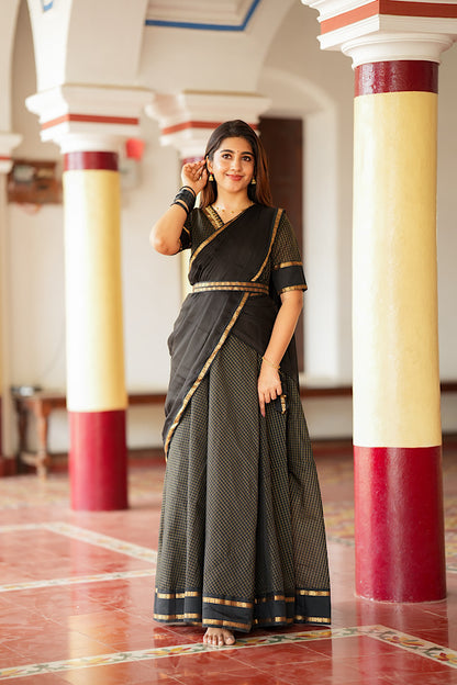 Fusion wear dress in black Aarani silk styled with a gold-bordered fabric belt