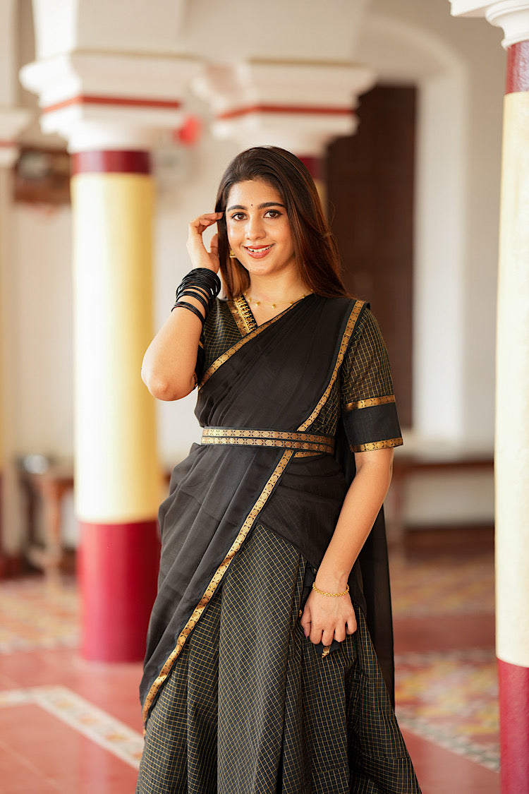 Close-up of the fabric belt holding the draped black dupatta in place