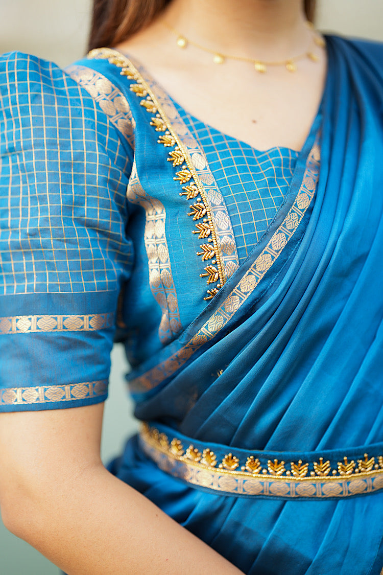 Detailed view of the Aari embroidery on the yoke of the peacock blue crop top