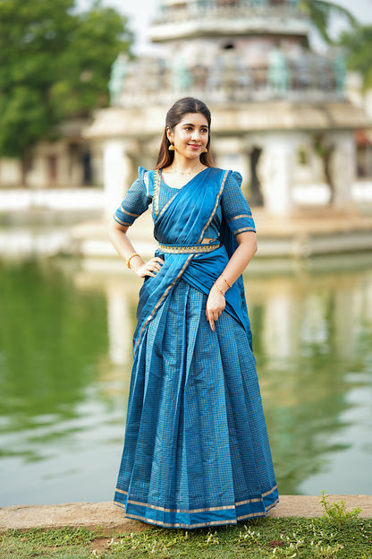 Pleated Up peacock blue half saree set styled with a pleated dupatta and gold belt