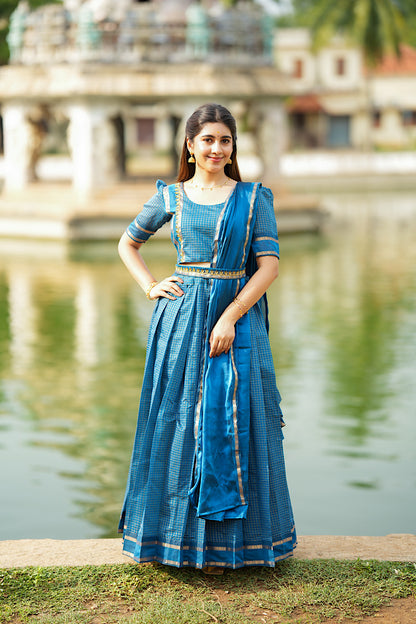 Front view of the peacock blue crop top skirt with dupatta styled with an embroidered belt