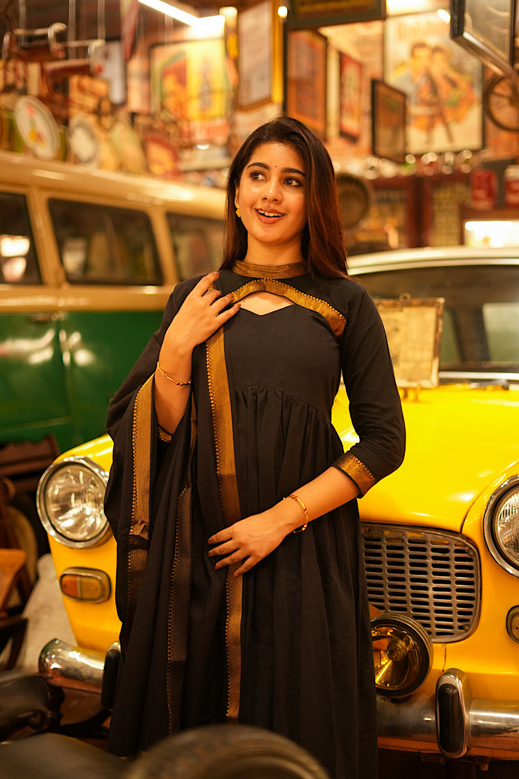 Side view of the black Mangalgiri cotton Alia cut suit set showing the gathered waist and 3/4 sleeves.