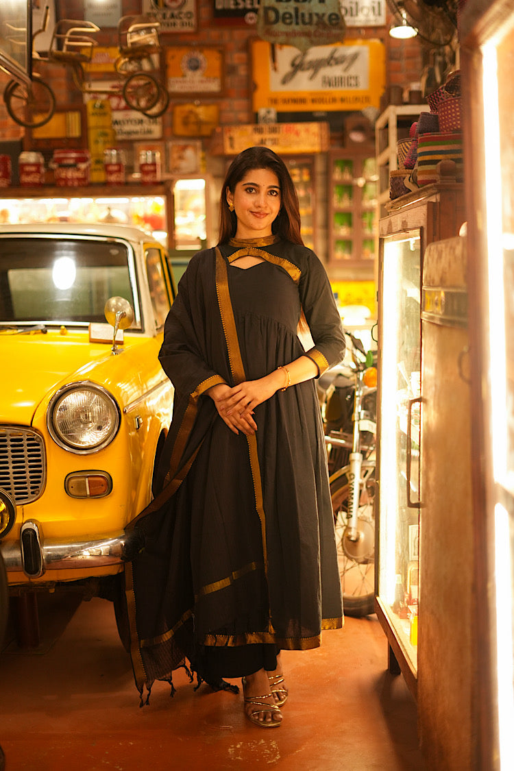 Black anarkali suit set in Mangalgiri cotton with gold zari borders and a matching dupatta.