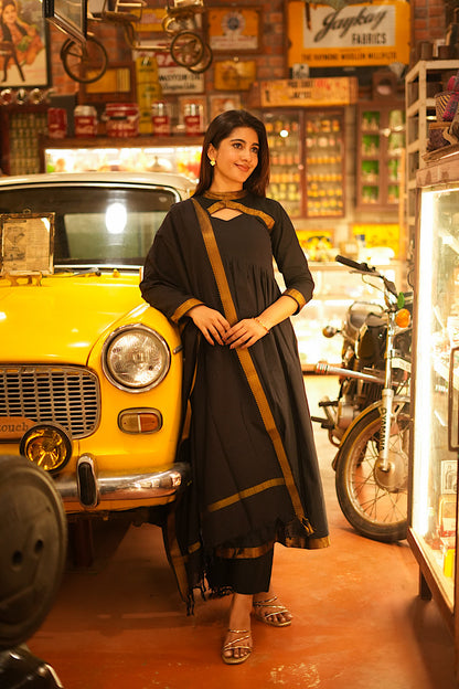 Alia cut black anarkali suit set featuring a high collar keyhole neckline and straight pants.