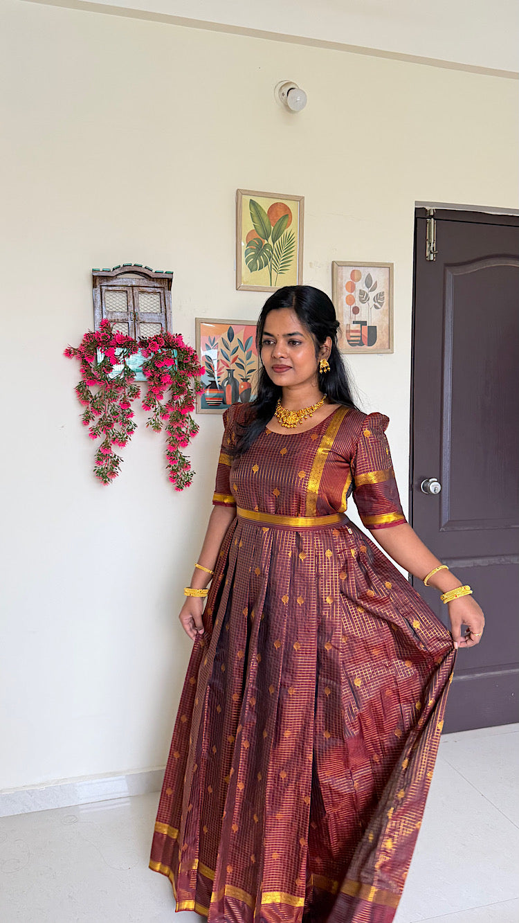 Close up of coffee brown silk maxi dress bodice with gold zari motifs and round neck