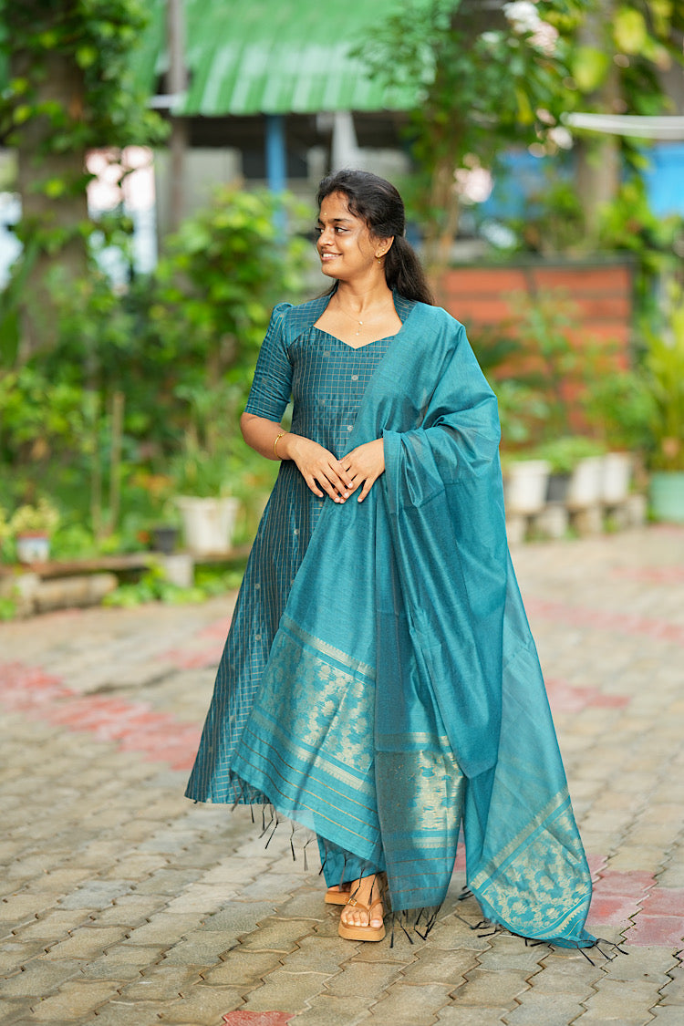 Full view of teal blue raw silk A-line kurta set with dupatta