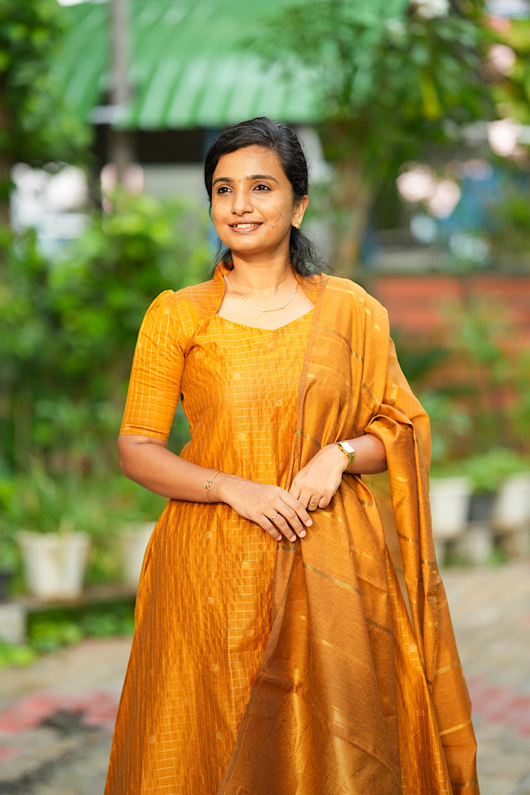 Mustard yellow raw silk kurti set with dupatta styled for festive wear