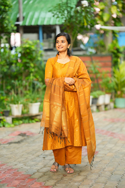 Flared mustard yellow raw silk kurta set with draped woven zari border dupatta