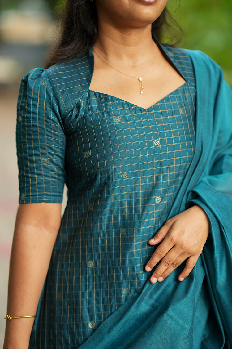 Detail of gold check weave and woven motifs on raw silk fabric