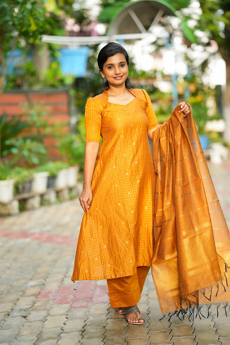 A line kurti set in yellow raw silk showing flare and straight matching pants