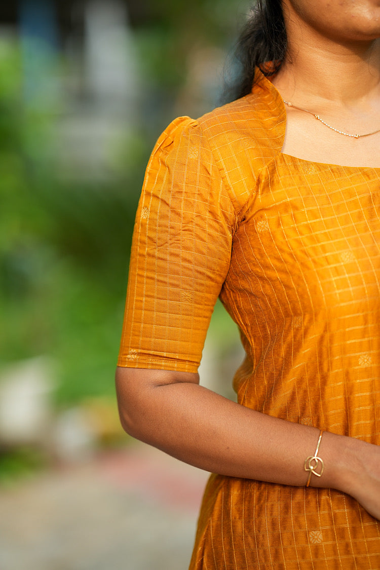 Detailed view of elbow length puff sleeve on yellow raw silk kurta
