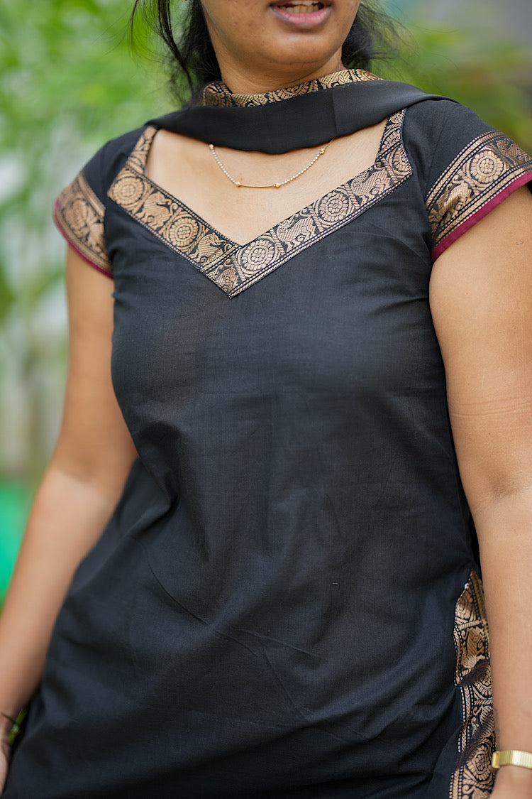 V-neckline detail with gold zari brocade on black cotton kurta