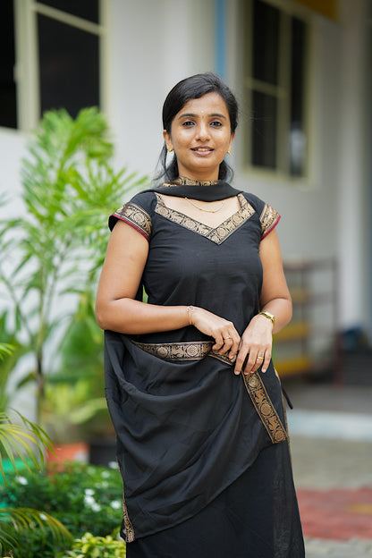 Model wearing black ethnic suit set outdoors