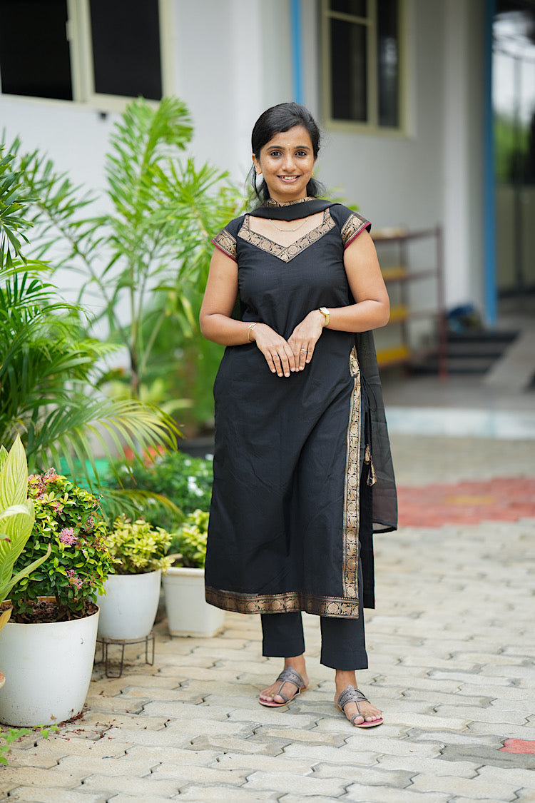 black cotton kurti set - Black Chettinad cotton kurta set with gold zari borders on model standing