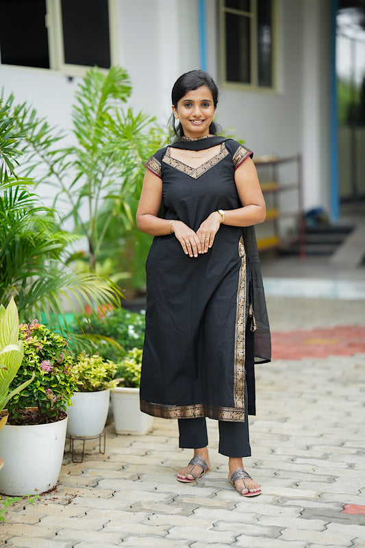 black cotton kurti set - Black Chettinad cotton kurta set with gold zari borders on model standing