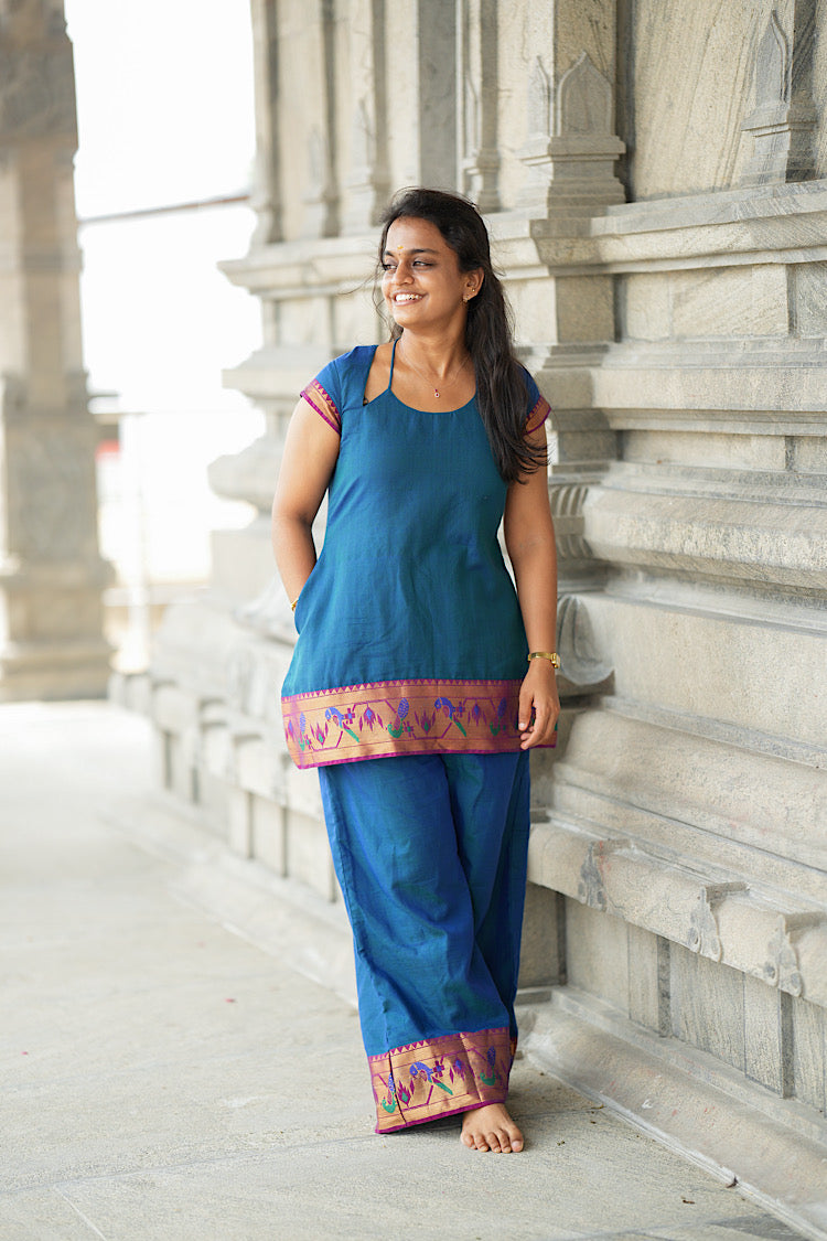 Short peacock blue tunic top with side pockets and paithani border trim