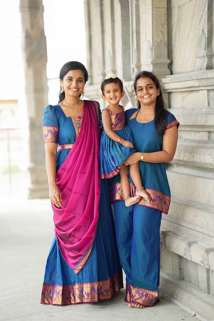 Sleeveless peacock blue tunic top with shoulder straps and woven zari hem