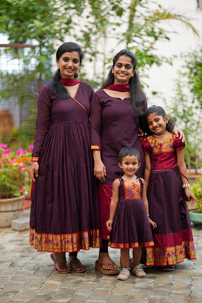 Women and kids wearing matching wine maroon paithani ethnic wear sets