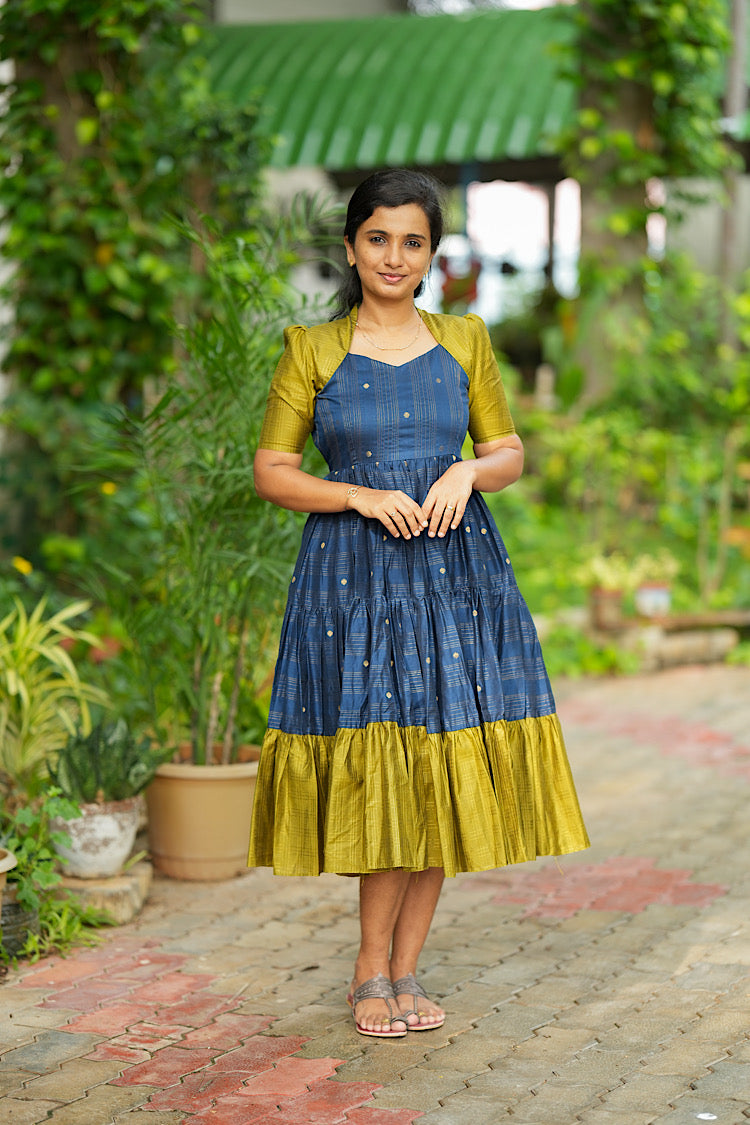 Standing full length view of raw silk midi dress in blue green combo
