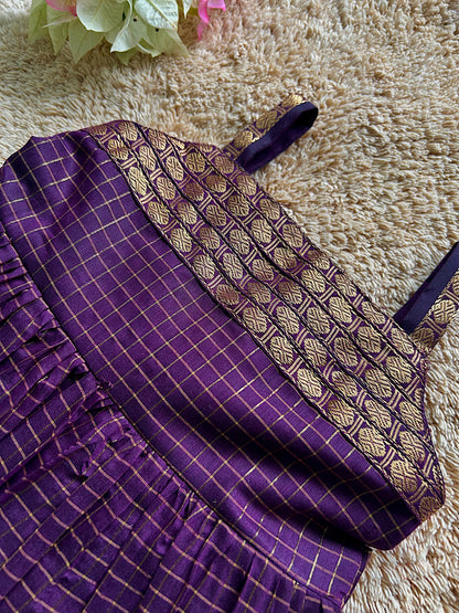 Close-up of gold zari yoke and straps on wine silk frock for kids