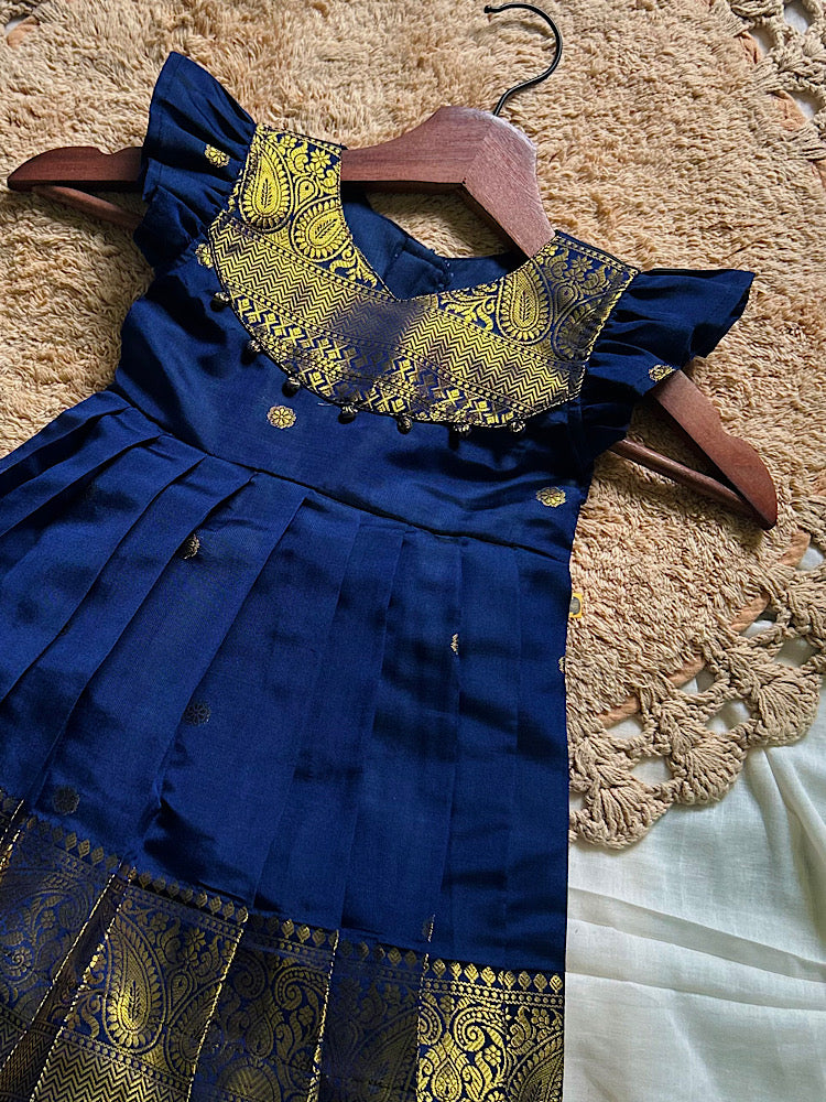 Close-up of royal blue kids ethnic silk frock showing golden zari weave yoke and pleated border