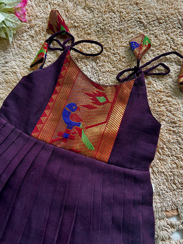 Detailed close-up of woven zari paithani parrot motif yoke on brown frock