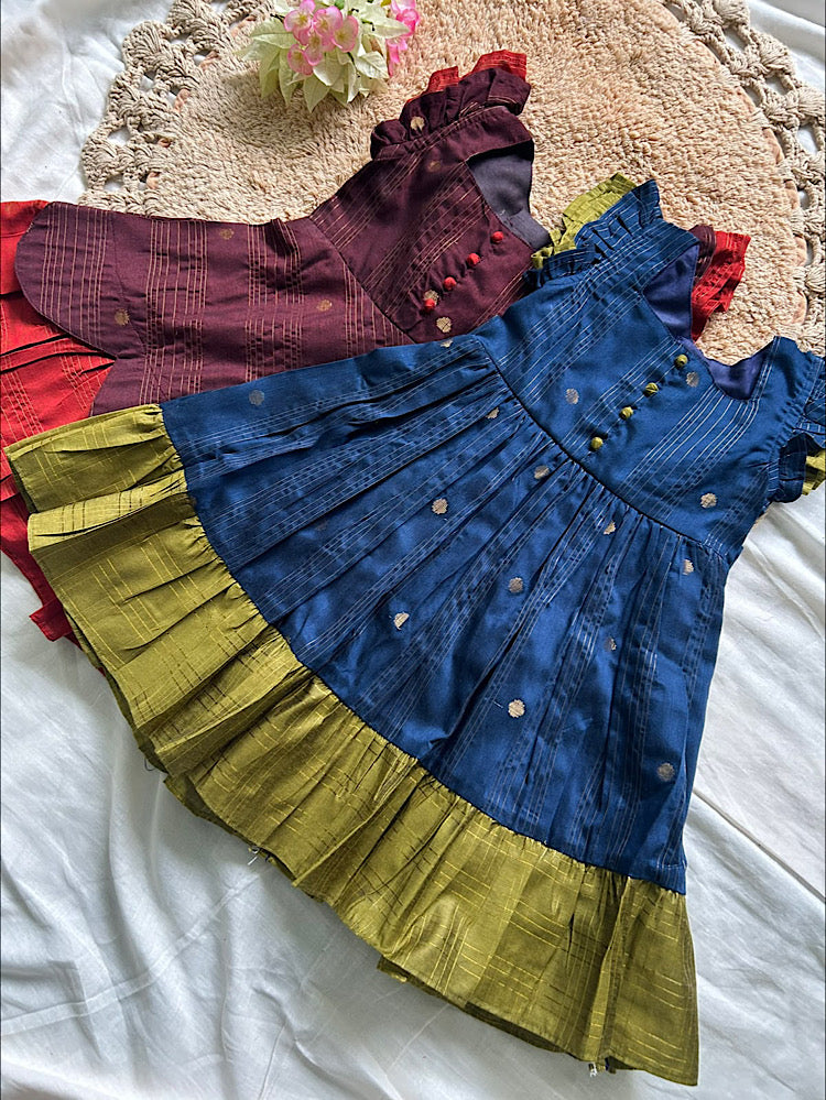 Flat lay of traditional silk frock for girls in blue and olive green color combination