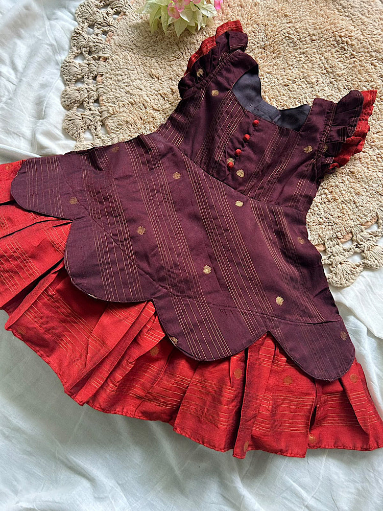 Flat lay of coffee brown and rust orange kids ethnic silk frock featuring potli buttons and ruffle sleeves