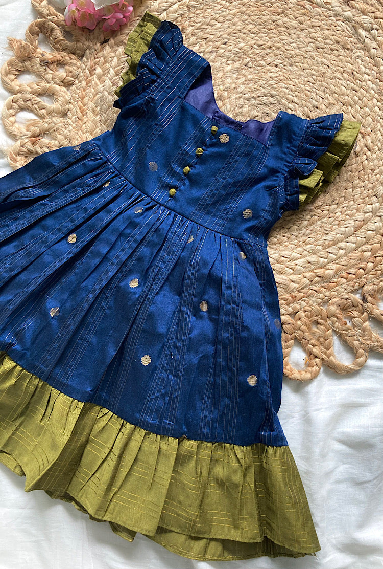 Close up of blue raw silk kids festive frock showing ruffled sleeves and potli buttons