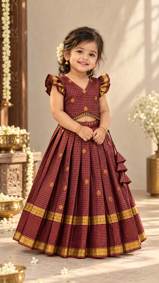 Coffee brown checks kids lehenga choli with ruffle sleeves, beaded crop top hemline, and pleated skirt with gold zari border