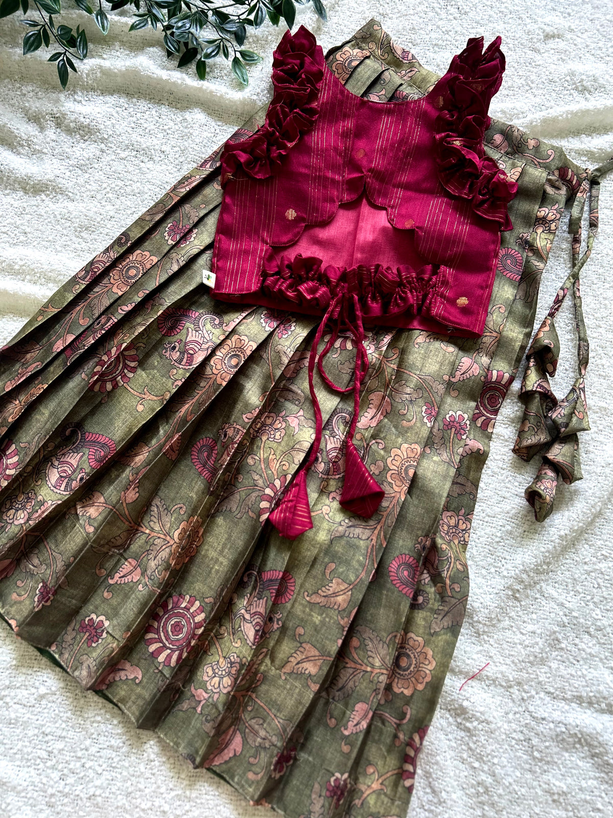Back view of maroon crop top featuring scalloped cut-out and dori tie-up