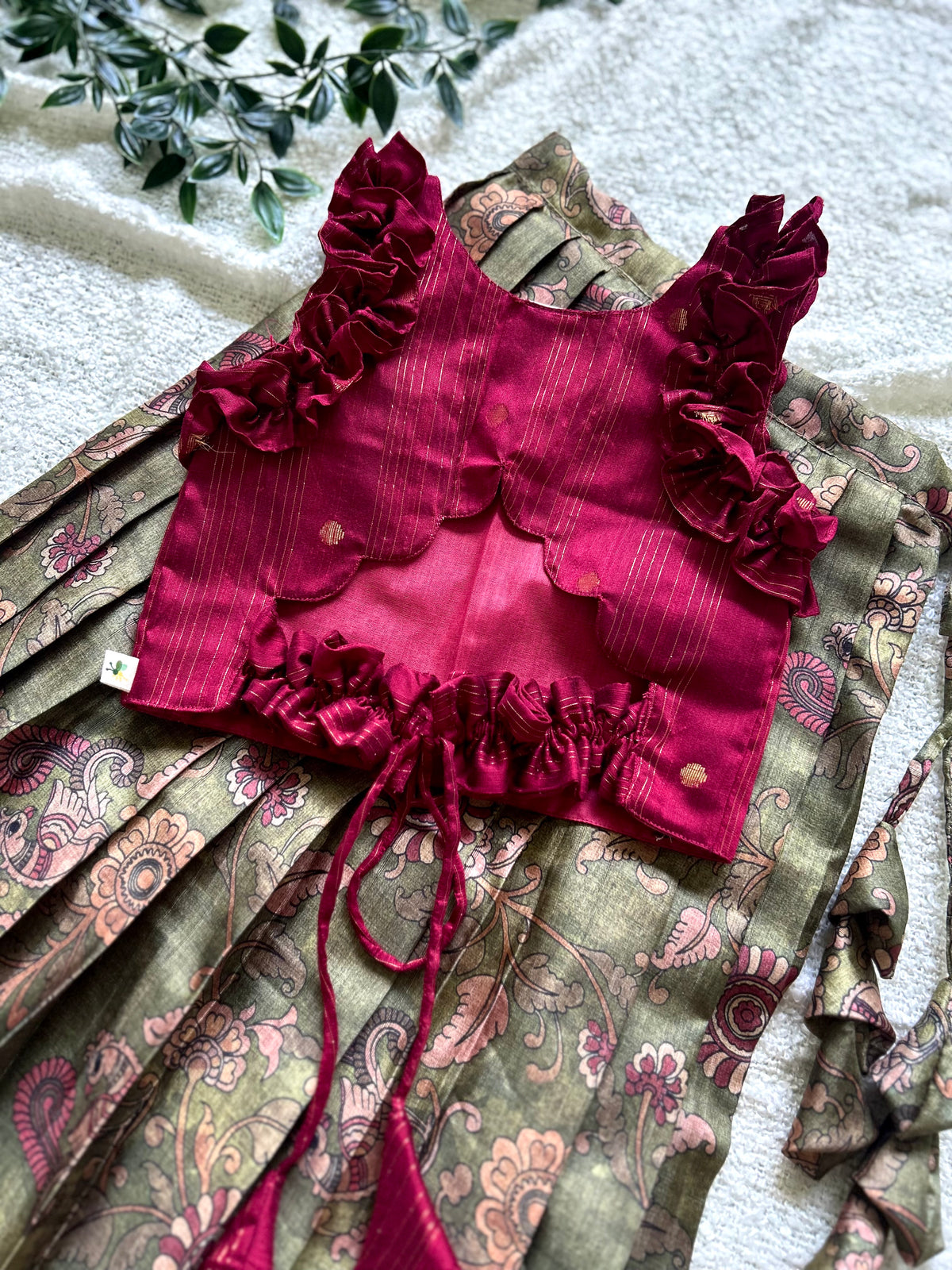 Back layout of maroon silk crop top with olive green kalamkari skirt