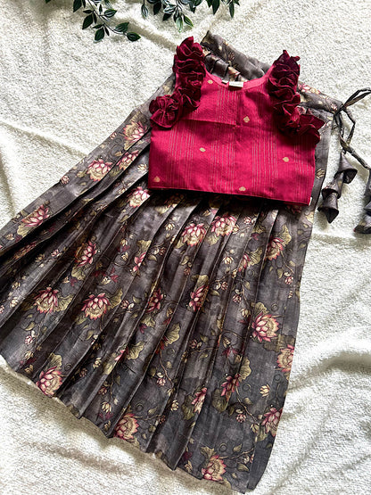 Flat lay of maroon raw silk crop top with ruffles and grey floral pleated skirt